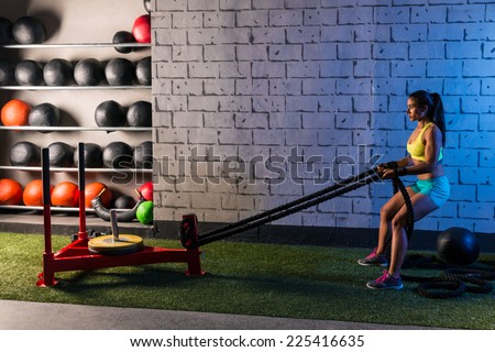 sled rope pull woman pulling weights workout exercise