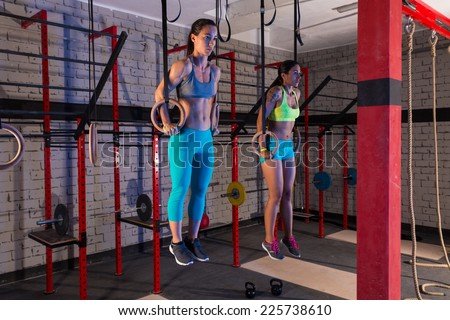 Gym girls muscle ups rings workout at gym