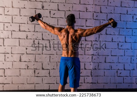 gym man rising hex dumbbells weightlifting rear view