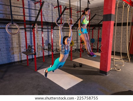 Gym girls muscle ups rings swinging workout at gym