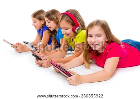 sisters cousins kid girls with tech tablets and smartphones in a row lying on white background