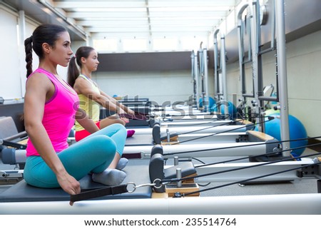 Pilates reformer workout exercises women at gym indoor