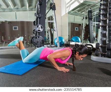 brunette woman at gym knees push up push-up workout exercise