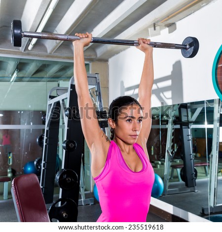 brunette narrow grip barbell shoulder press workout at gym