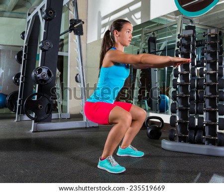Air squat woman workout exercise at gym