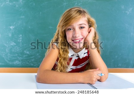 Happy student expression schoolgirl in classroom desk at school green chalk board