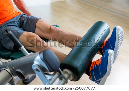 Leg extension exercise man at gym indoor workout