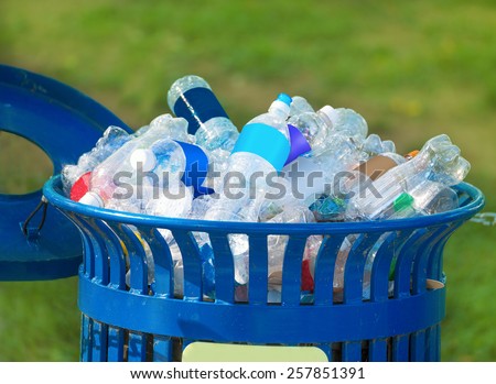 Trash bin full of beverage empty bottles in summer thirsty day