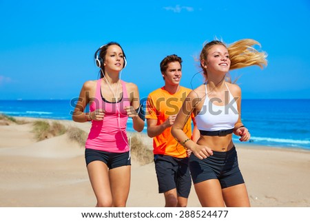 friends running on the beach happy in summer sunny day