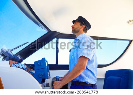 Captain cap sailor boating modern yacht boat indoor with beard