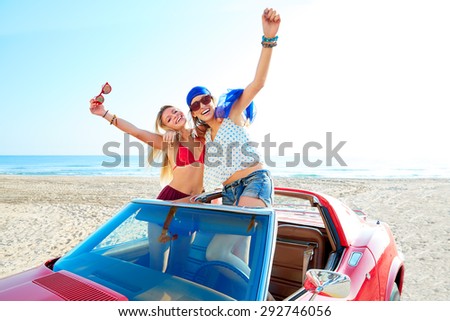 Beautiful party friend girls dancing in a car on the beach happy