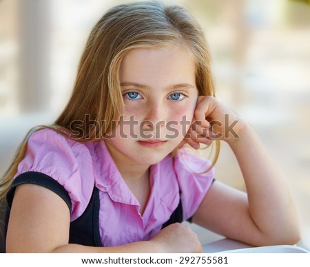 Blond relaxed sad kid girl expression blue eyes portrait