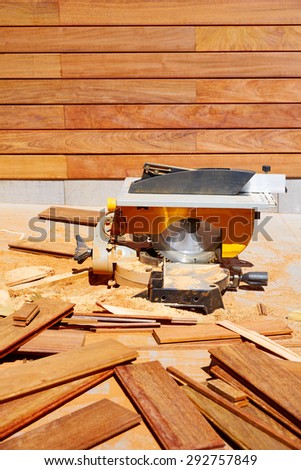 Ipe wood fence installation with carpenter table circular saw and sawdust