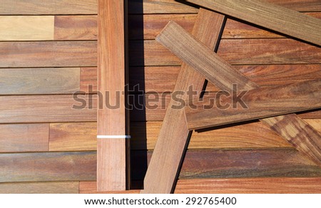 Ipe decking installation with wood slats and flooring background