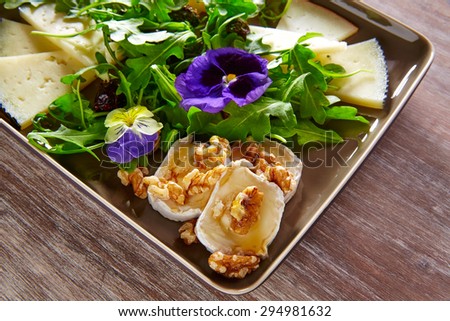 Arugula mediterranean salad with goat cheese honey flowers and nuts