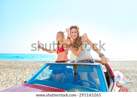 Beautiful party friend girls dancing in a car on the beach happy