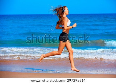 Beautiful brunette girl running in the beach at summer vacations