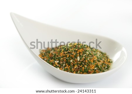 Multicolor vegetables semolina textures in white dish, white background