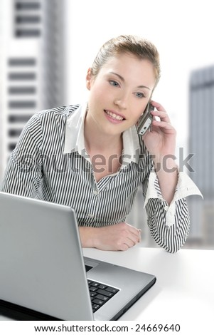 Businesswoman with laptop happy talking with mobile phone [Photo Illustration]