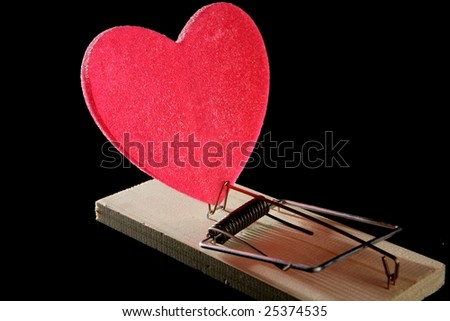 Love and health as a mouse trap. Metaphor with red candy heart