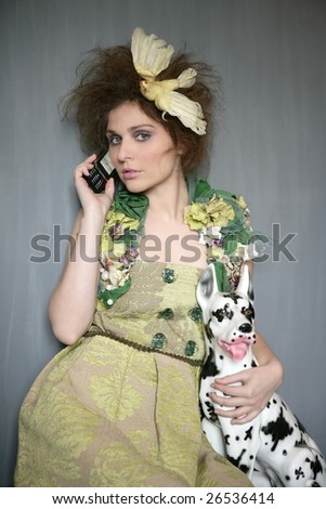 Modern fashion original woman talking phone with dalmatian dog