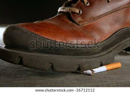 broken cigarette tread by a boot, tobacco addiction metaphor