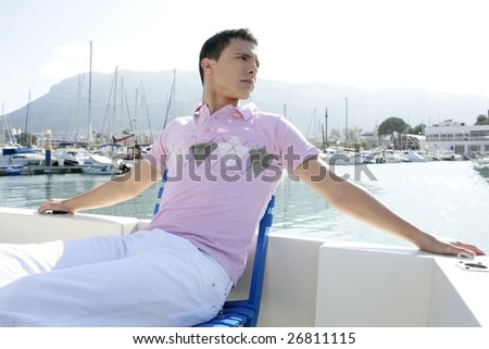 Young handsome man relaxed in vacation with his boat