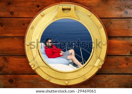 Man relaxed on bean bag over blue sea, view from boat round window [Photo Illustration]