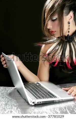 Attractive brunette fashion woman with laptop over black