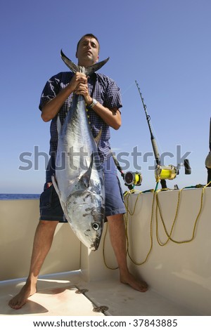 Angler fishing big game bluefin tuna on Mediterranean saltwater