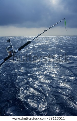 Big game boat fishing in deep sea on boat under cloudy winter time