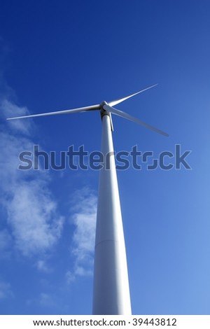 Electric wind mill viewed from the floor over blue sky, ecological windmill