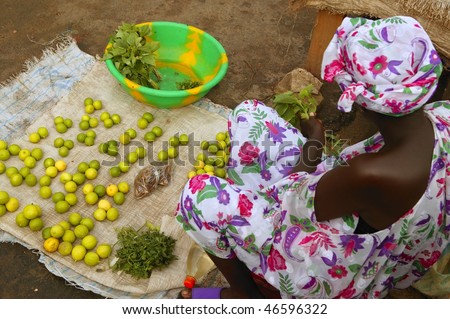 African market bird view lemon limes and colorful dress woman