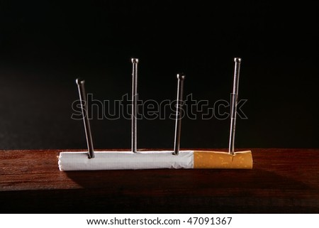 Nicotine tobacco addiction concept metaphor cigarette and nails