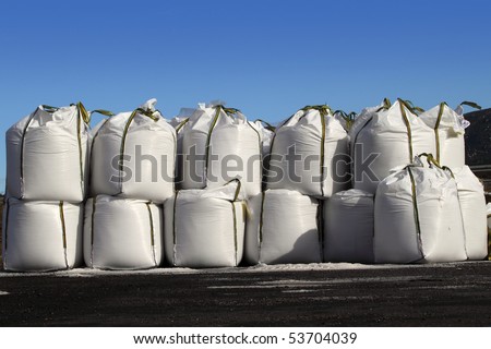 salt big bags sacks stacked rows for iced roads blue sky