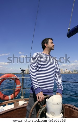 blue sailor man sailing vintage wooden sailboat mediterranean sea