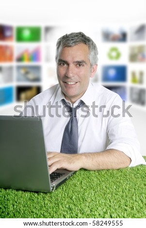 happy senior businessman working green grass desk tv presenter screen [Photo Illustration]