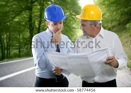 engineer two expertise team plan talking hardhat forest road [Photo Illustration]