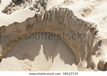 landslide hole detail beach sand aerial view half circle