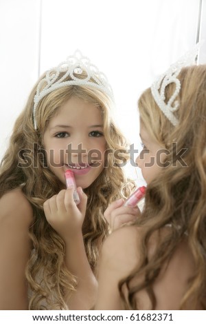 princess little girl painting makeup lipstick on the mirror