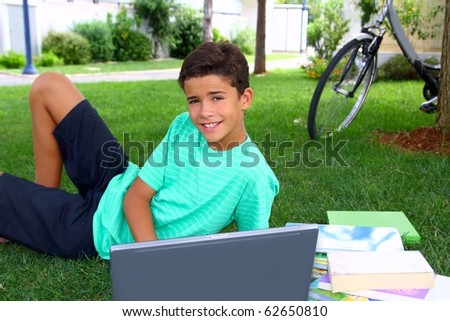 boy teenager student homework sitting grass garden laptop computer
