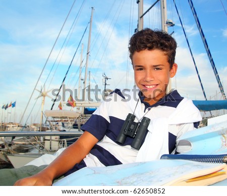 stock photo boy teen sailor laying on marina boat chart map smiling in