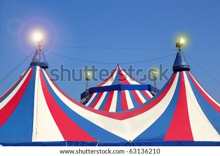 Circus tent under blue sky colorful stripes red white [Photo Illustration]