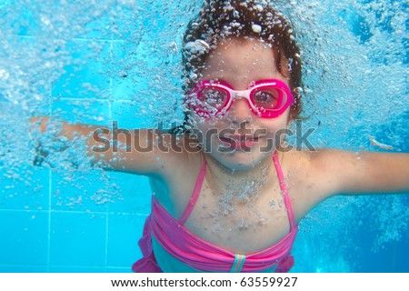 underwater little girl pink bikini goggles blue swimming pool