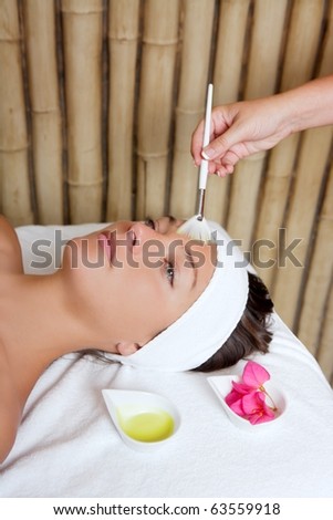 spa beauty facial treatment oil brush and bougainvillea flowers
