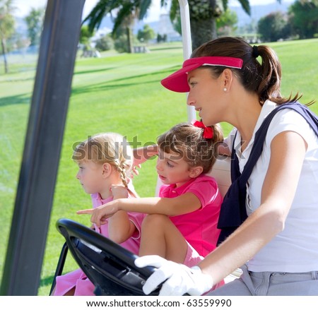 golf course family mother and daughters in buggy green grass field