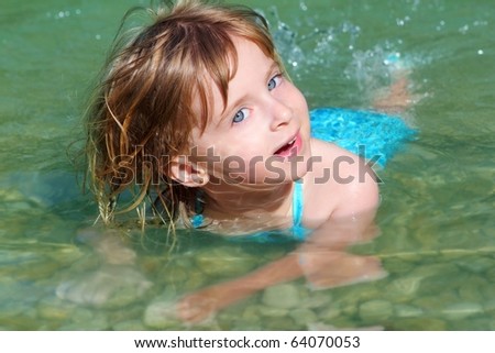 blond girl swimming in lake river beautiful blue eyes child