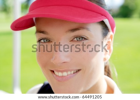 sport woman closeup portrait face smiling sun visor cap tennis golf