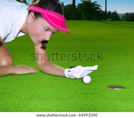 Golf green hole course woman humor flicking hand a ball inside in short putt