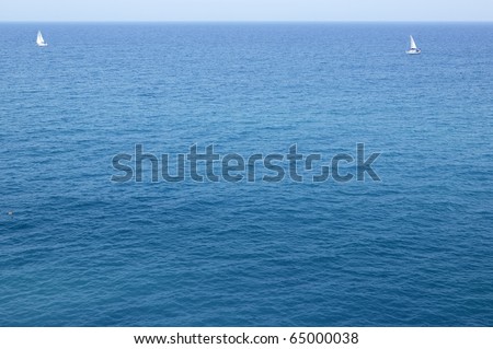 Blue sea with sailboat sailing the ocean surface summer vacation